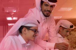 An Arab father with his two children using a laptop.
