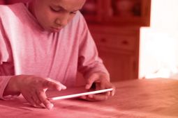 A boy using a tablet.