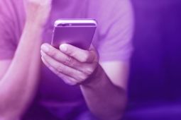 Hand of a man holding a smartphone.