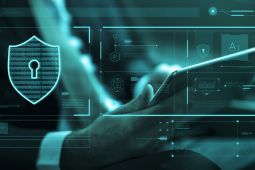 Hand of a man holding a tablet with the illustration of a lock next to it.
