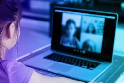 A child having a video call with her classmates.