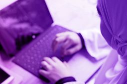 A young girl using a laptop.